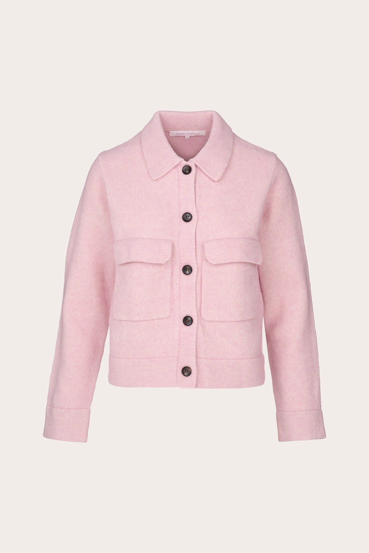 A light pink cropped jacket with a pointed collar, front button closure, and two flap pockets, shown on a plain light beige background.