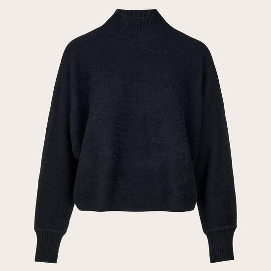 A black cropped mock-neck knit sweater with long sleeves and ribbed cuffs, displayed on a clean, light beige background.