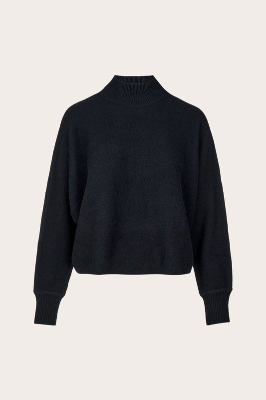 A black cropped mock-neck knit sweater with long sleeves and ribbed cuffs, displayed on a clean, light beige background.