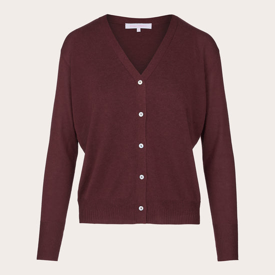 A burgundy knit cardigan sweater with a V-neck, long sleeves, and a button-up front, displayed on a neutral light beige background.