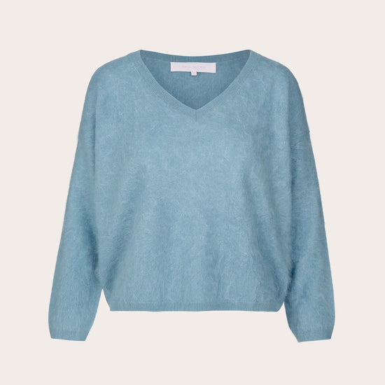 A light blue V-neck knit sweater with long sleeves, shown flat against a solid off-white background.