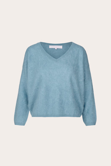 A light blue V-neck knit sweater with long sleeves, shown flat against a solid off-white background.