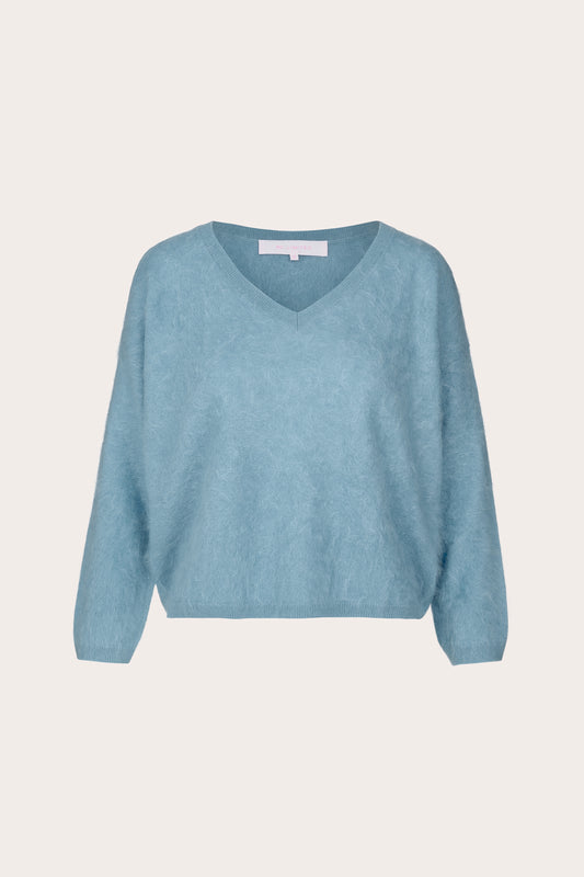 A light blue V-neck knit sweater with long sleeves, shown flat against a solid off-white background.