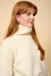 model shot wearing cream thick roll neck knit close up