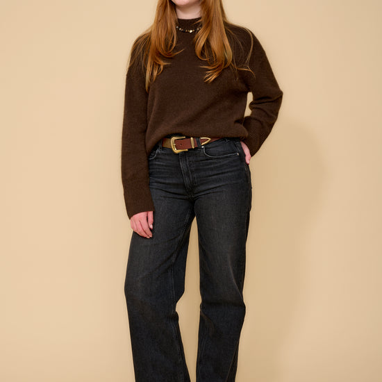 model shot wearing brown jumper black jeans and brown belt with a gold buckle