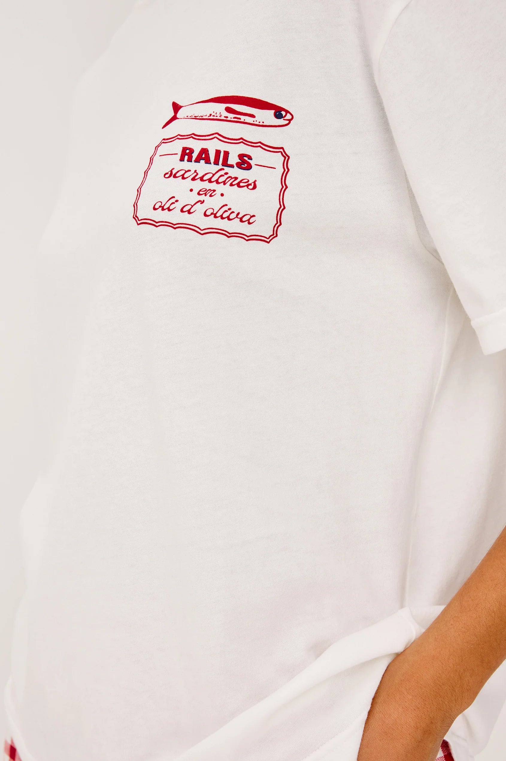 White t-shirt with red graphic design on a plain background from rails