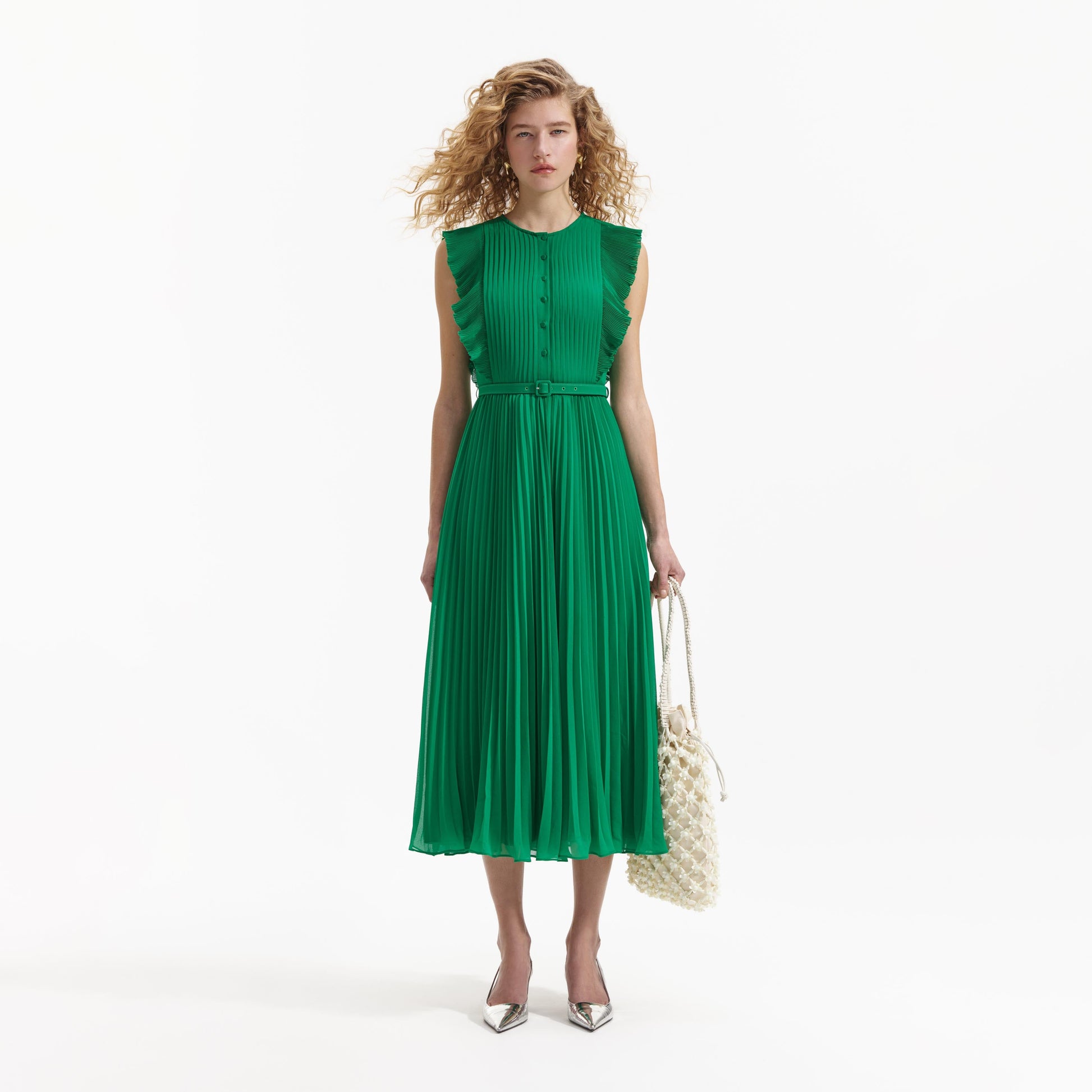 Emerald green sleeveless dress with pintuck bodice ruffle over the shoulder and midi length skirt with delicate pleats with fabric belt