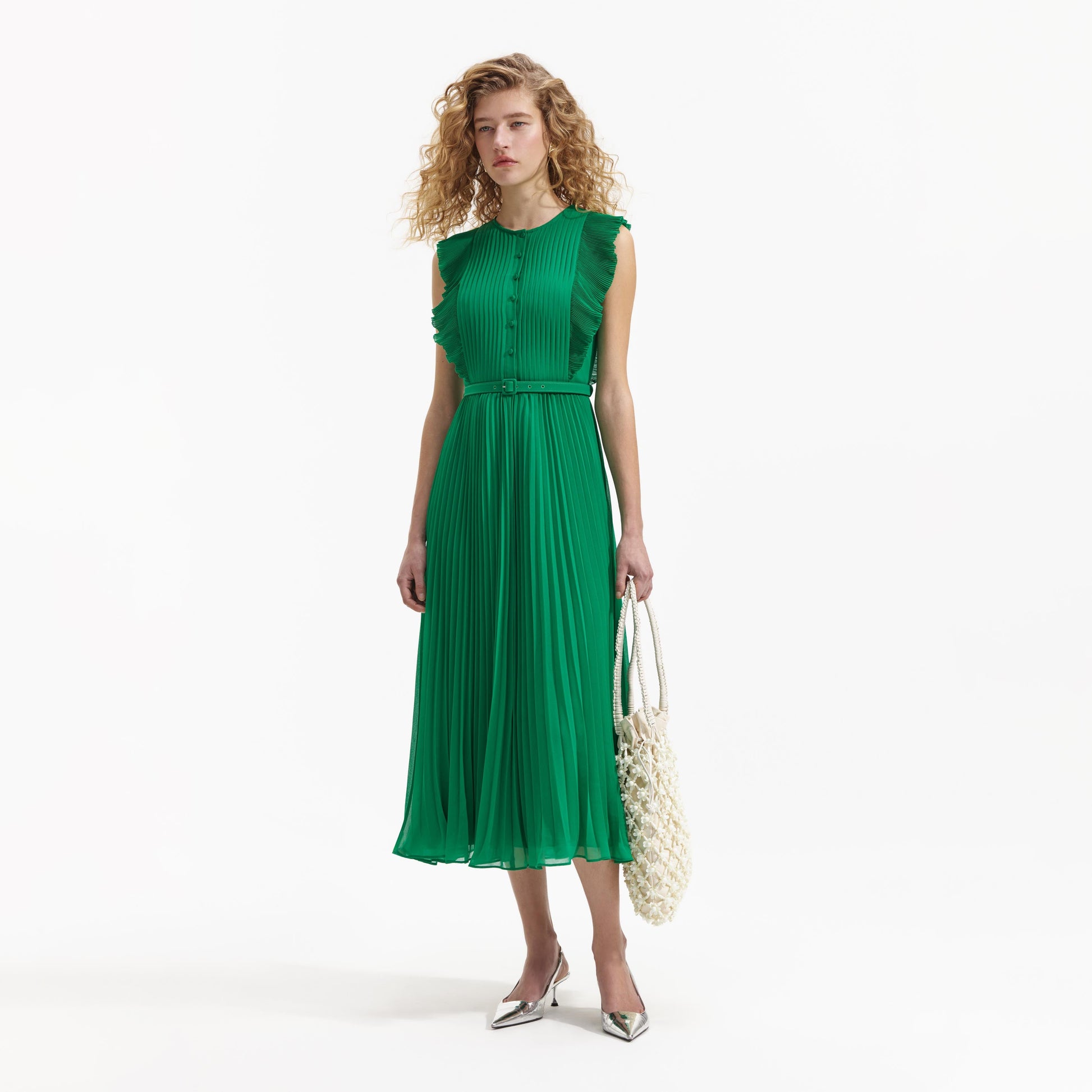 Emerald green sleeveless dress with pintuck bodice ruffle over the shoulder and midi length skirt with delicate pleats with fabric belt