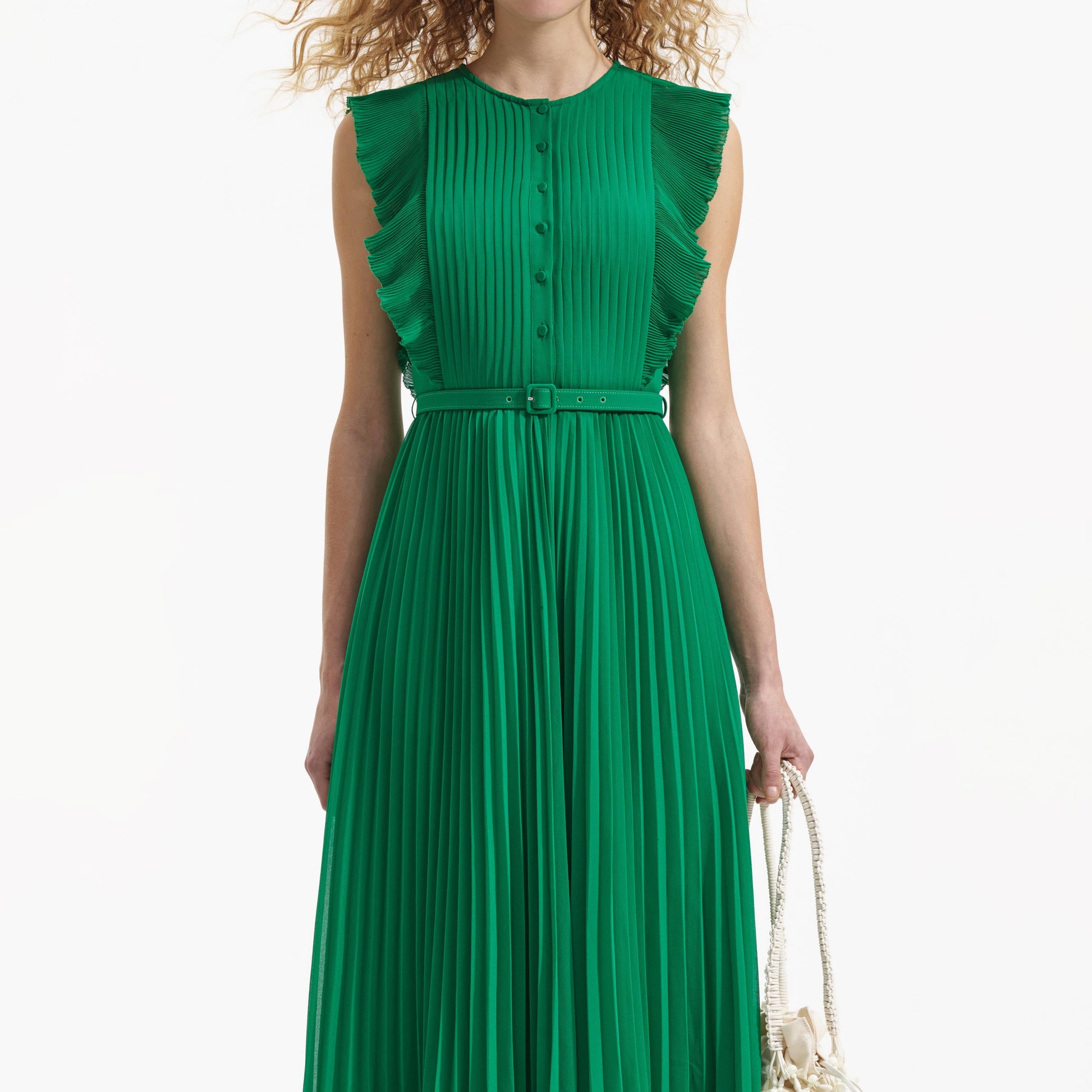 Emerald green sleeveless dress with pintuck bodice ruffle over the shoulder and midi length skirt with delicate pleats with fabric belt