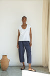White organic cotton top worn with blue trousers 