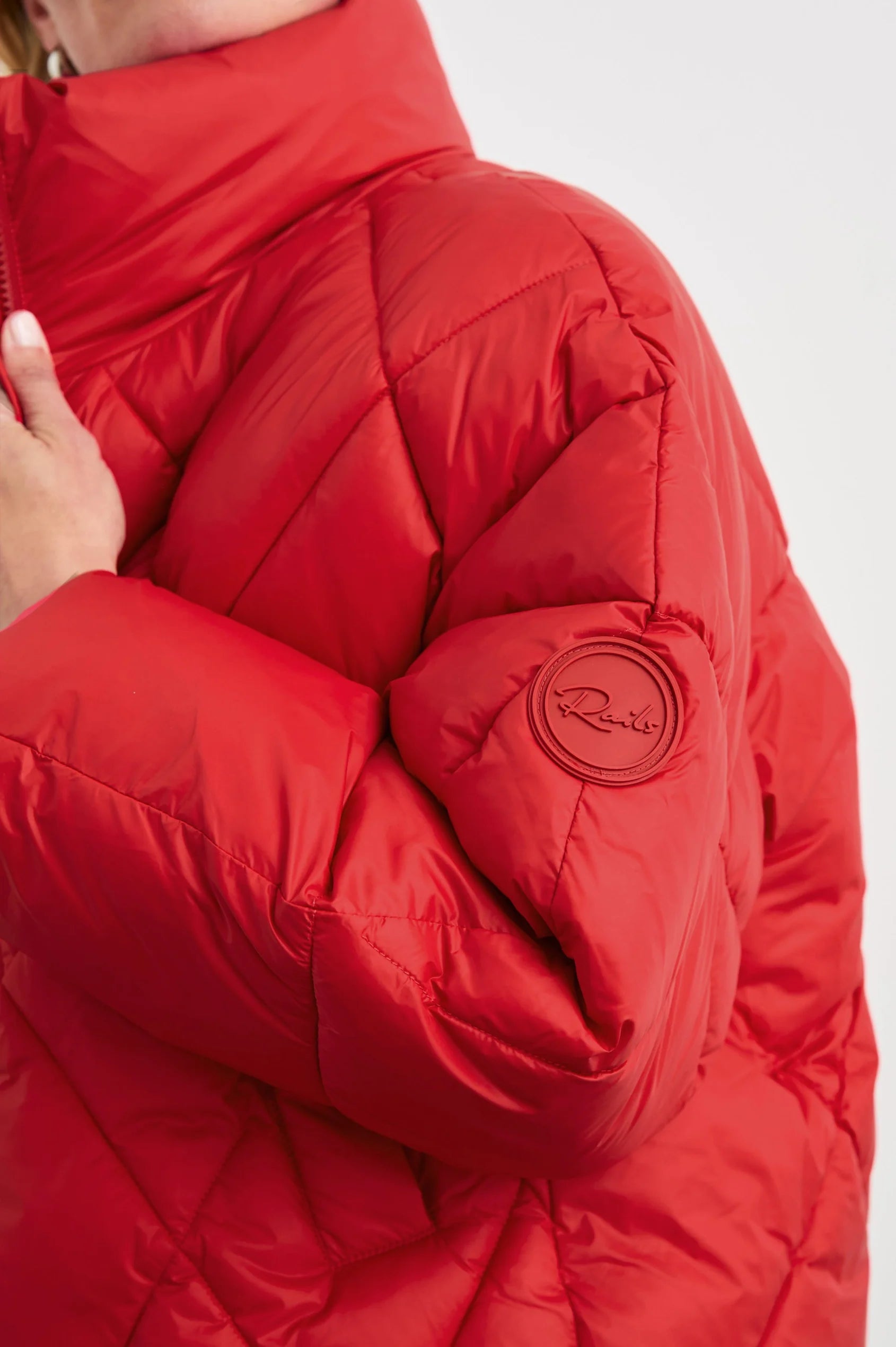 cropped red puffer jacket close up