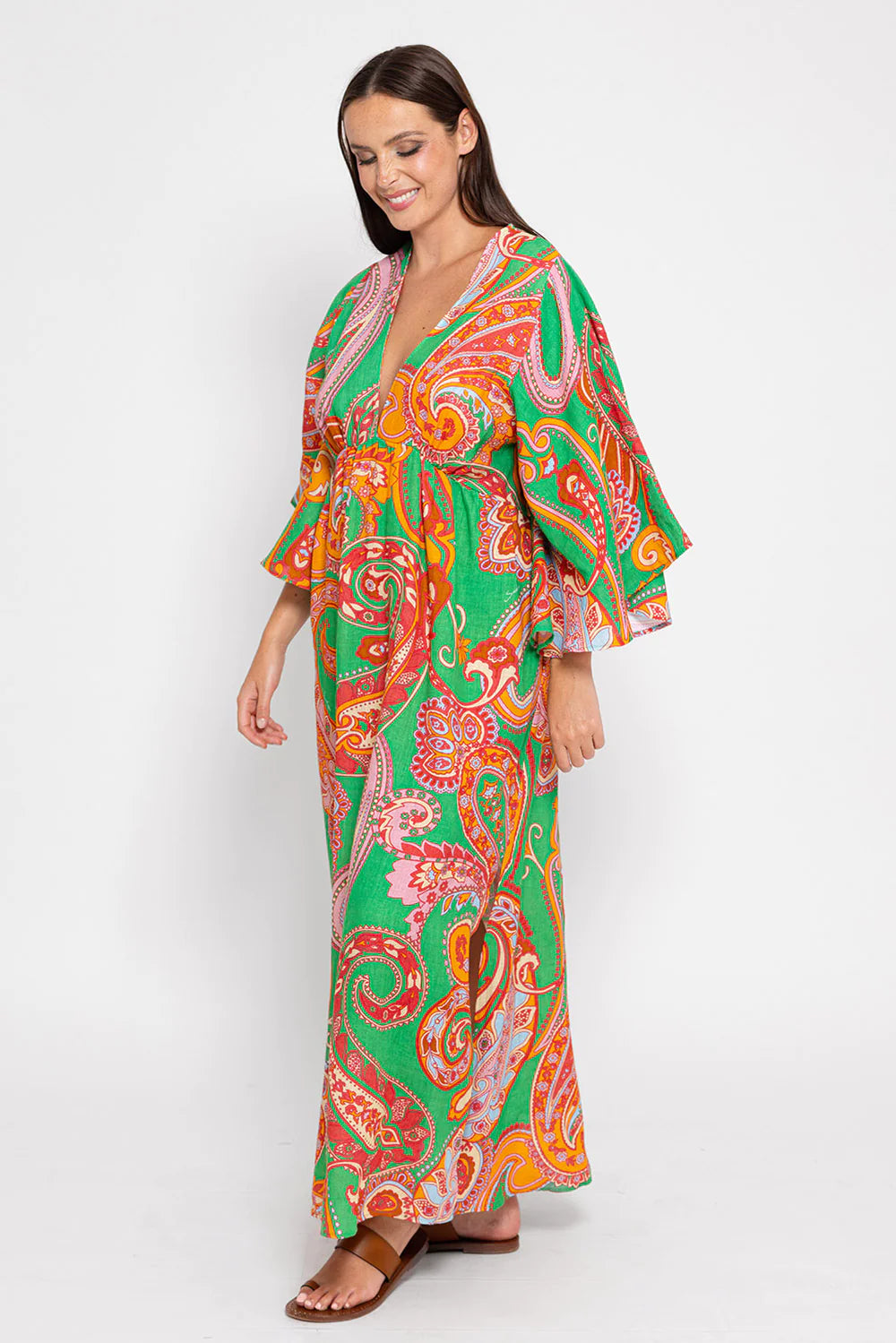 Green orange and red deep V midi dress with three quarter length fluted sleeves and side splits in green with paisley print