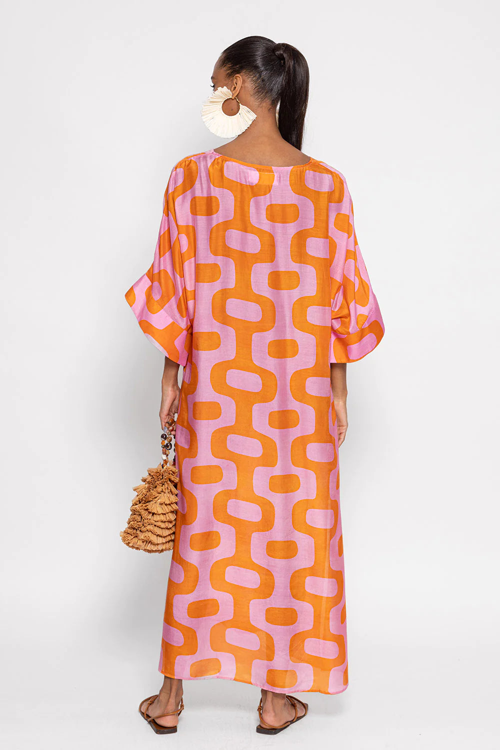 Pink and orange geometric patterned maxi kaftan dress with three quarter length grown on wide sleeves with V neck and two cut outs