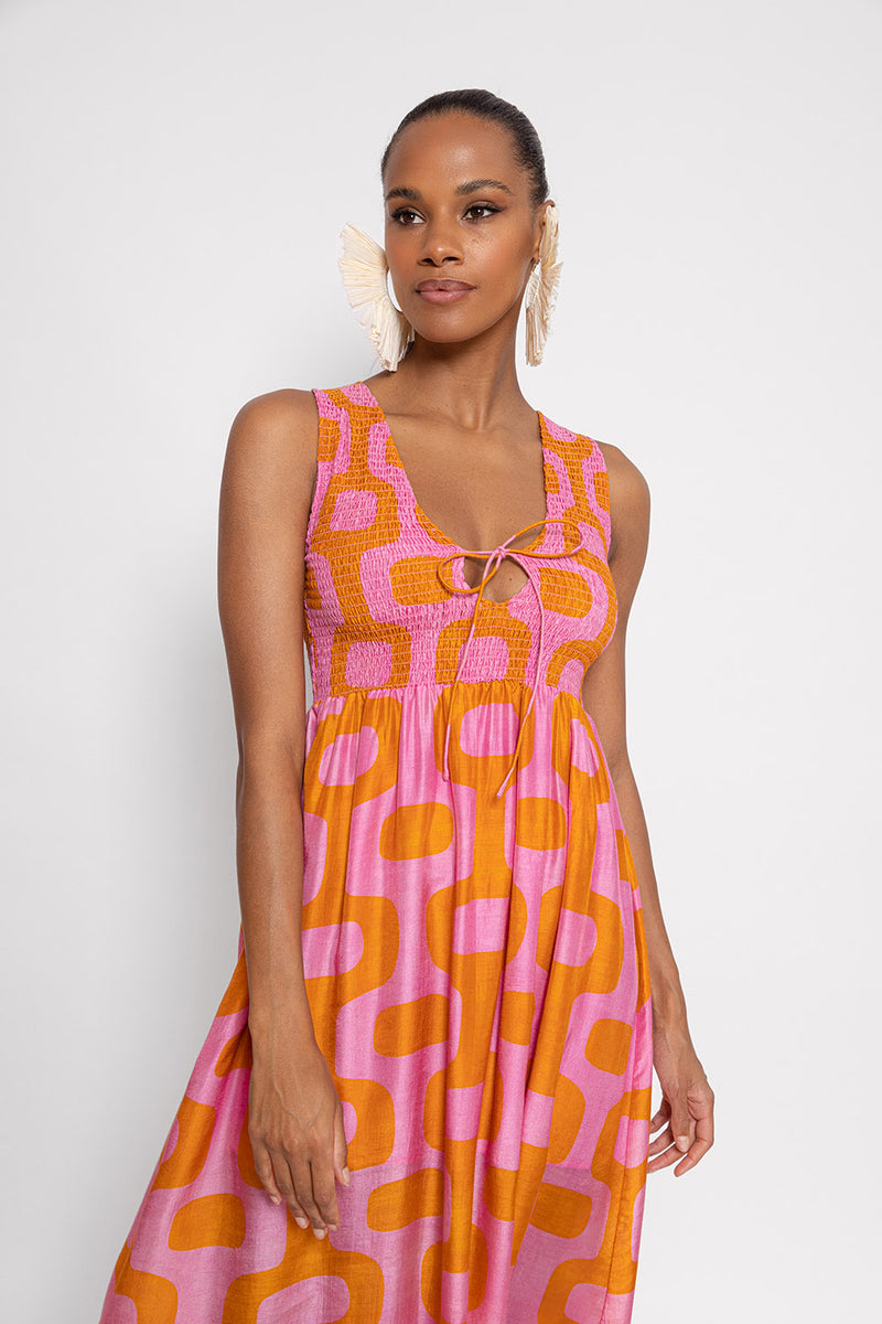 Pink and orange print dress with a smocked top and a V neck