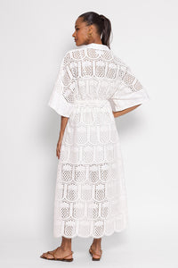 Notch neck off-shite broderie anglais midaxi dress with elbow length sleeves and front split lined to above the knee