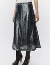 Person wearing a black sequin skirt on a white background