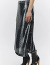 Silver sequin skirt worn by a person on a white background