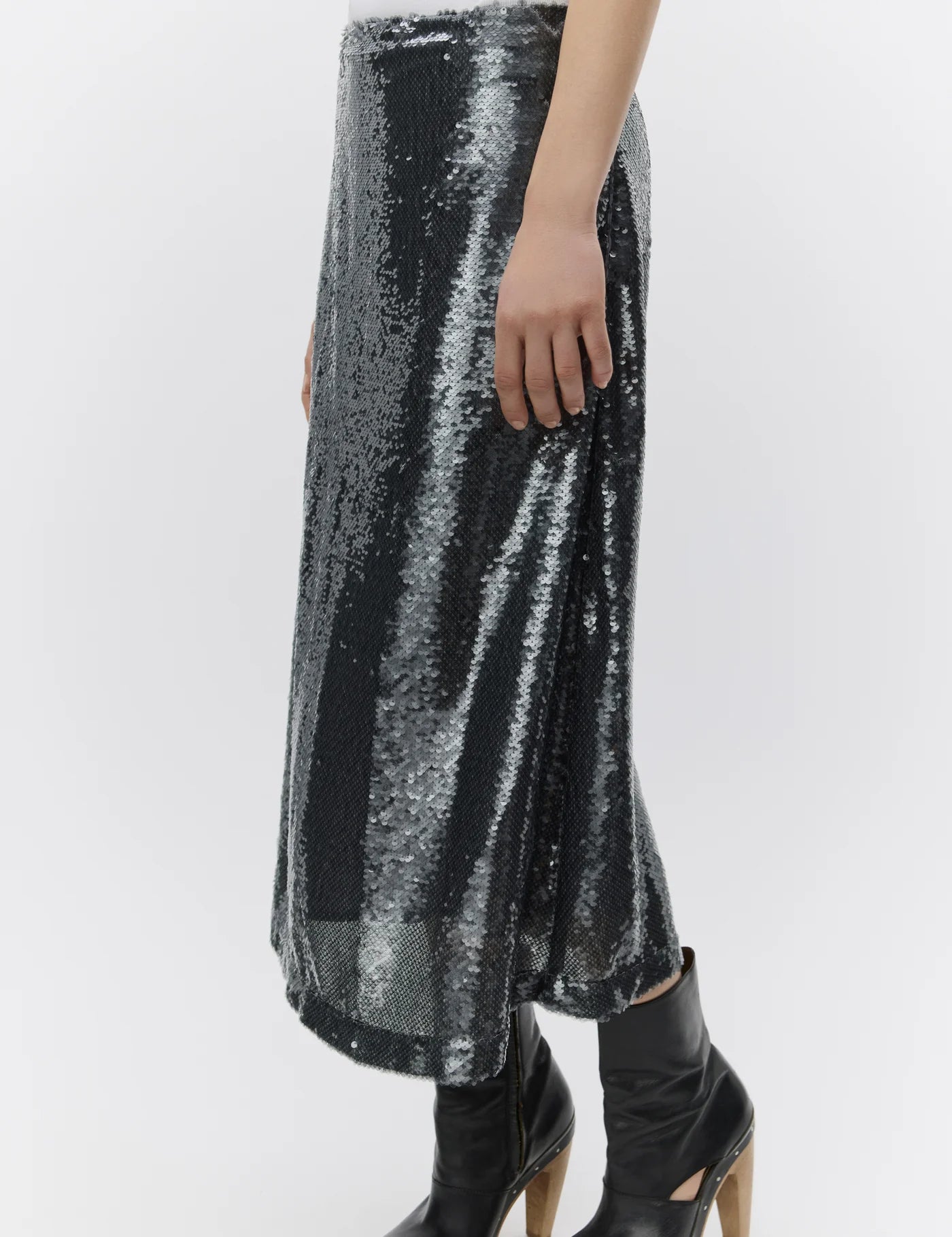 Silver sequin skirt worn by a person on a white background