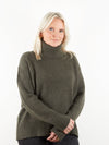 Dark green heavy gauge cashmere roll neck on model