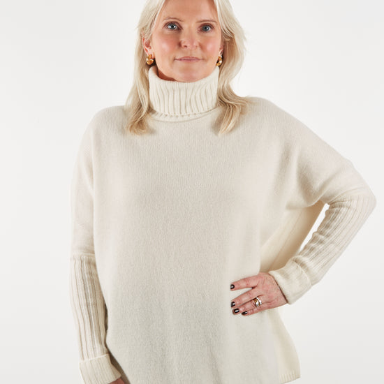 Ecru roll neck in heavy weight cashmere with a neat ribbed sleeve