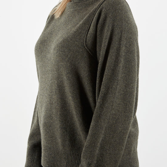 Side view of shoulder detail of cashmere knit in dark green