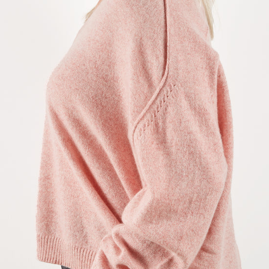 Side view of pink cashmere knit to show detail at the shoulder