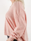 Side view of pink cashmere knit to show detail at the shoulder