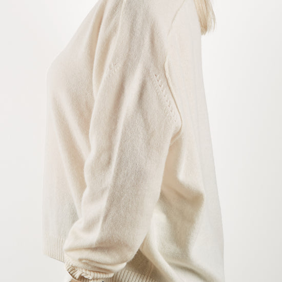 Side view of ecru cashmere knit