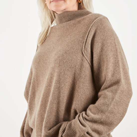 Side view of cashmere mid brown knit to show shoulder detail