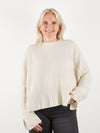 Cream round neck cashmere knit wiht deep rib hem and spits at the cuff