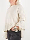 Side view of ecru cashmere knit with deep rib hem and side split at the cuff