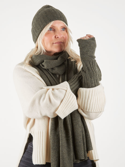 Dark green cashmere wristwarmers worn with matching scarf and hat