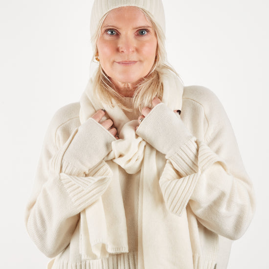 Cream cashmere wristwarmer hat and scarf set on model worn with cream cashmere  jumper