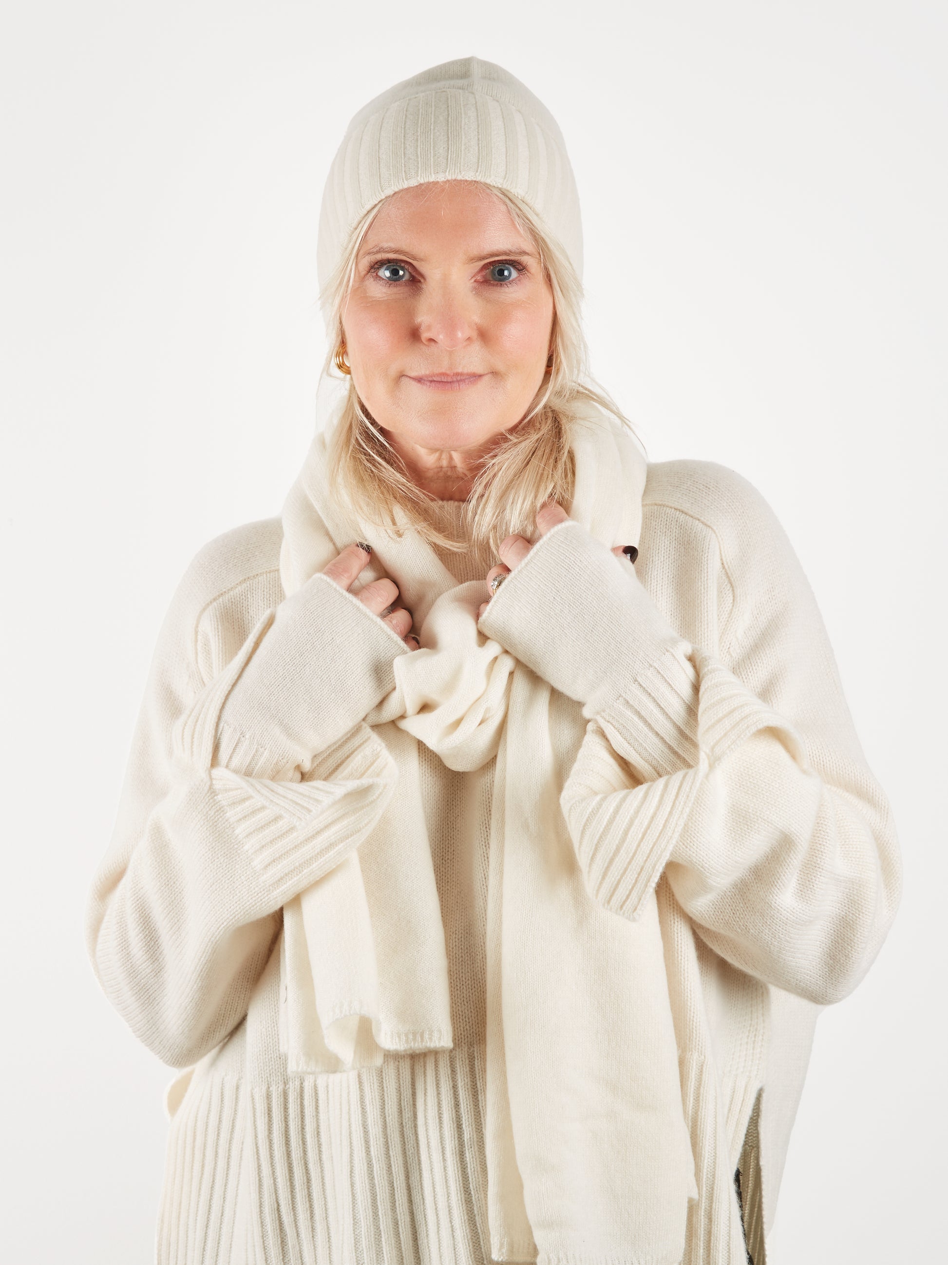 Cream cashmere wristwarmer hat and scarf set on model worn with cream cashmere  jumper