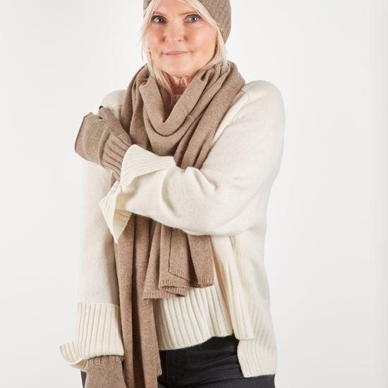 Cashmere wrist warmer scarf and hat worn with cream jumper on model