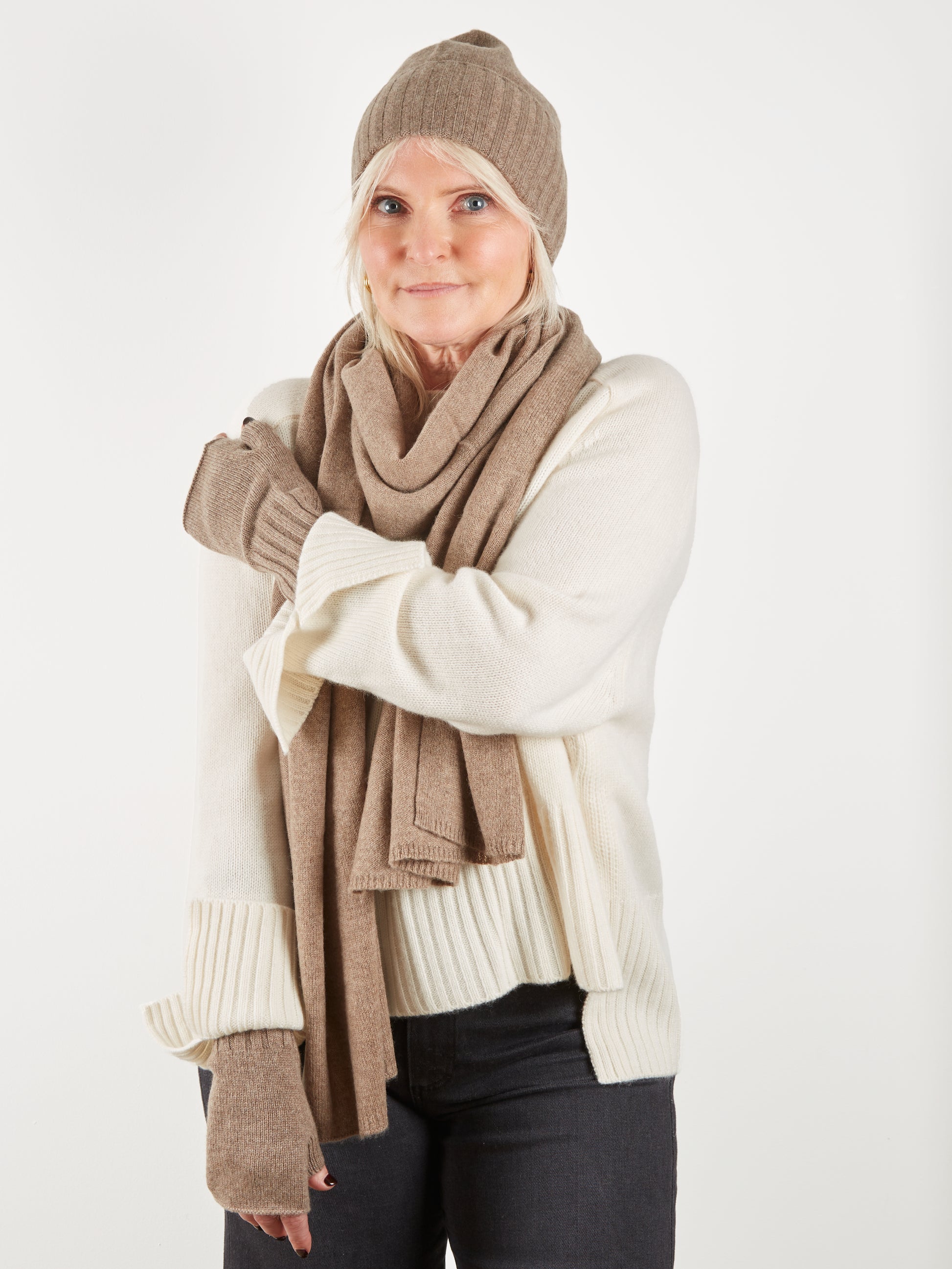 Cashmere wrist warmer scarf and hat worn with cream jumper on model