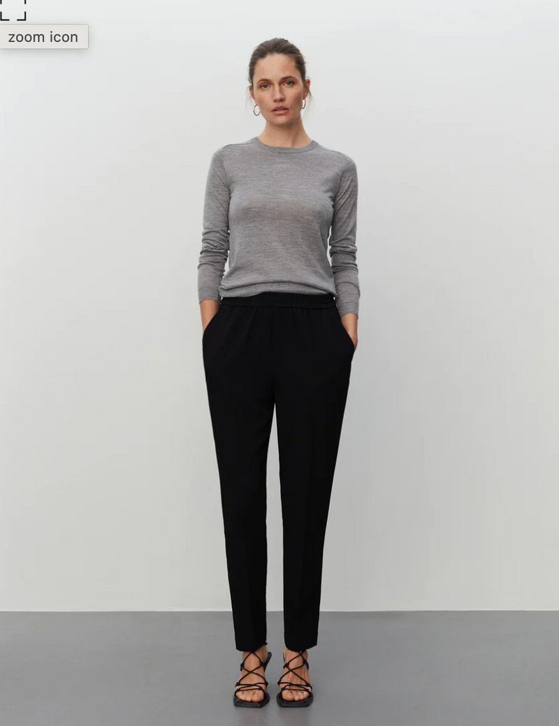 Pull on black tailored trousers with an elasticated waistband and side pockets