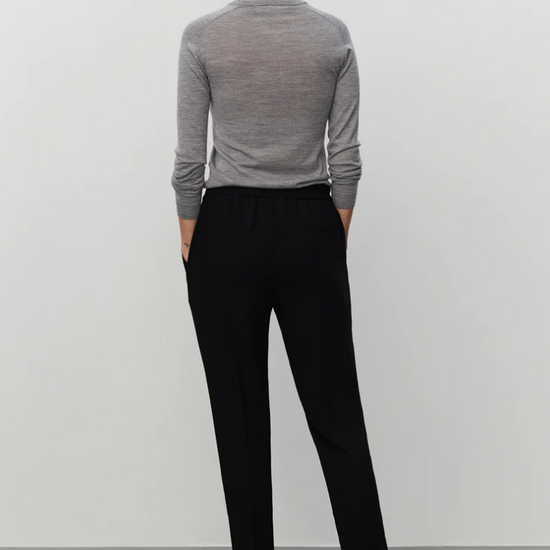 Pull on black tailored trousers with an elasticated waistband and side pockets