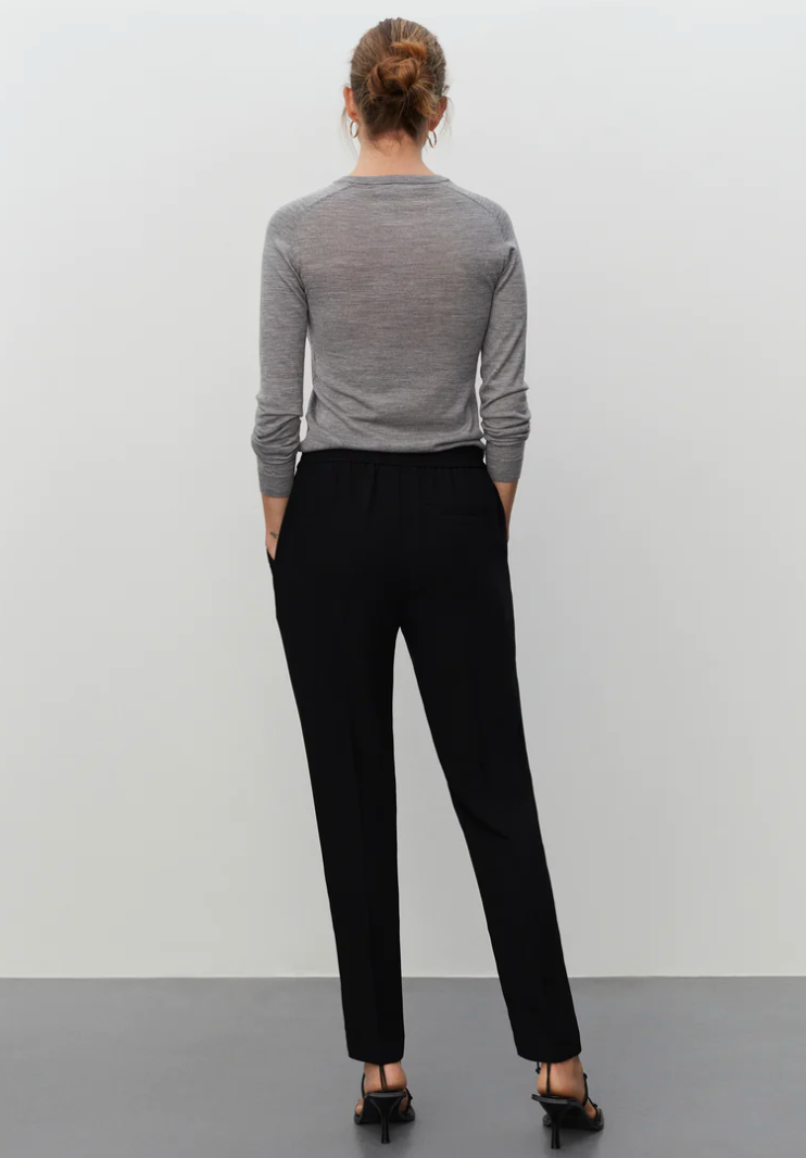 Pull on black tailored trousers with an elasticated waistband and side pockets