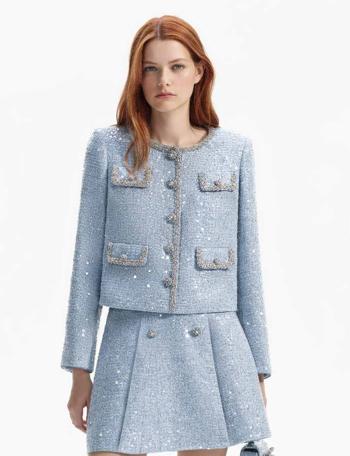 Light blue boucle jacket with sequin and rhinestone details featuring four patch pockets on the front with decorative trim