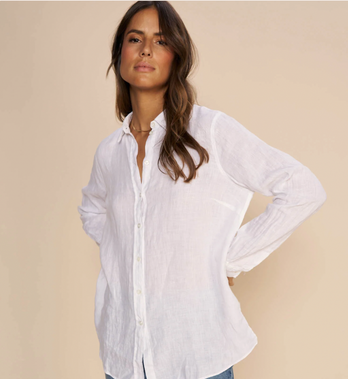 White linen shirt with classic collar and full length placket with white plastic button fastening and long sleeves with single button cuff