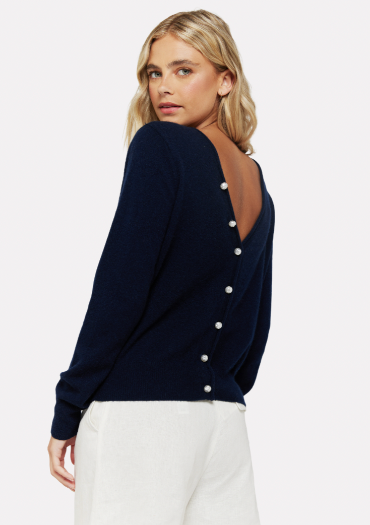Navy crew neck jumper with V shaped back and pearl button fasteningNavy crew neck jumper with V shaped back and pearl button fastening