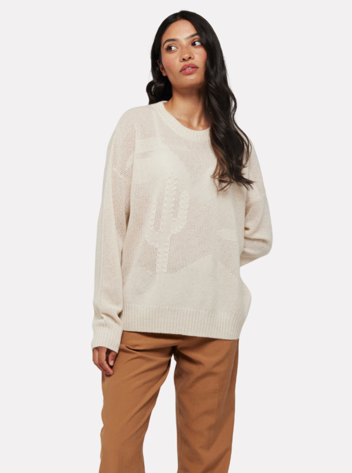 Cream jumper with different stitches creating a textured jumper featuring a desert and cactus scene