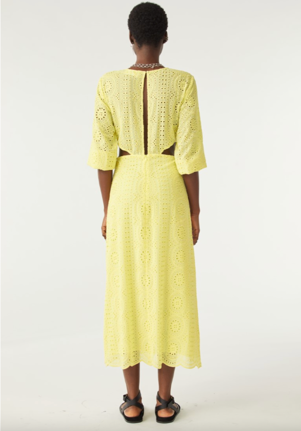 Yellow broderie anglais midi dress with three quarter length sleeves with waist cut outs and scalloped hem