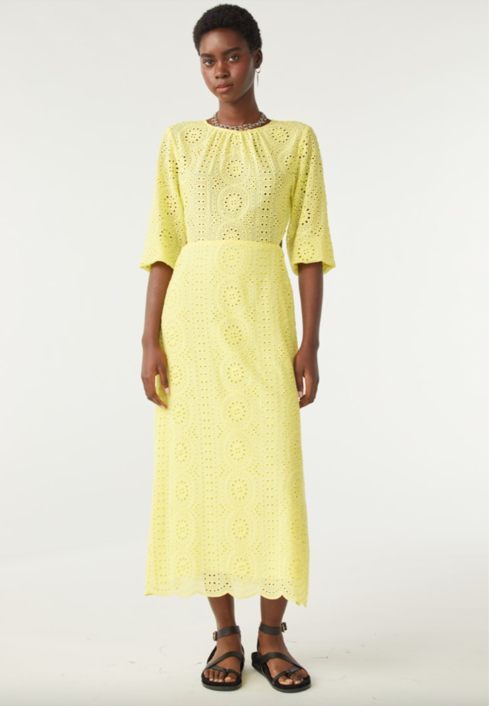 Yellow broderie anglais midi dress with three quarter length sleeves with waist cut outs and scalloped hem