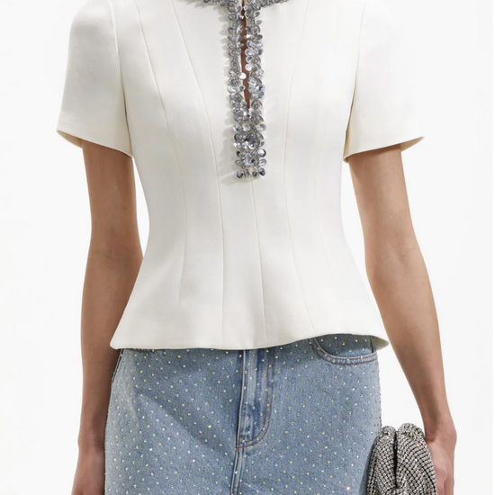 Ecru structured top with split crew neckline short sleeves and silver sequin and beaded detail about the neckline