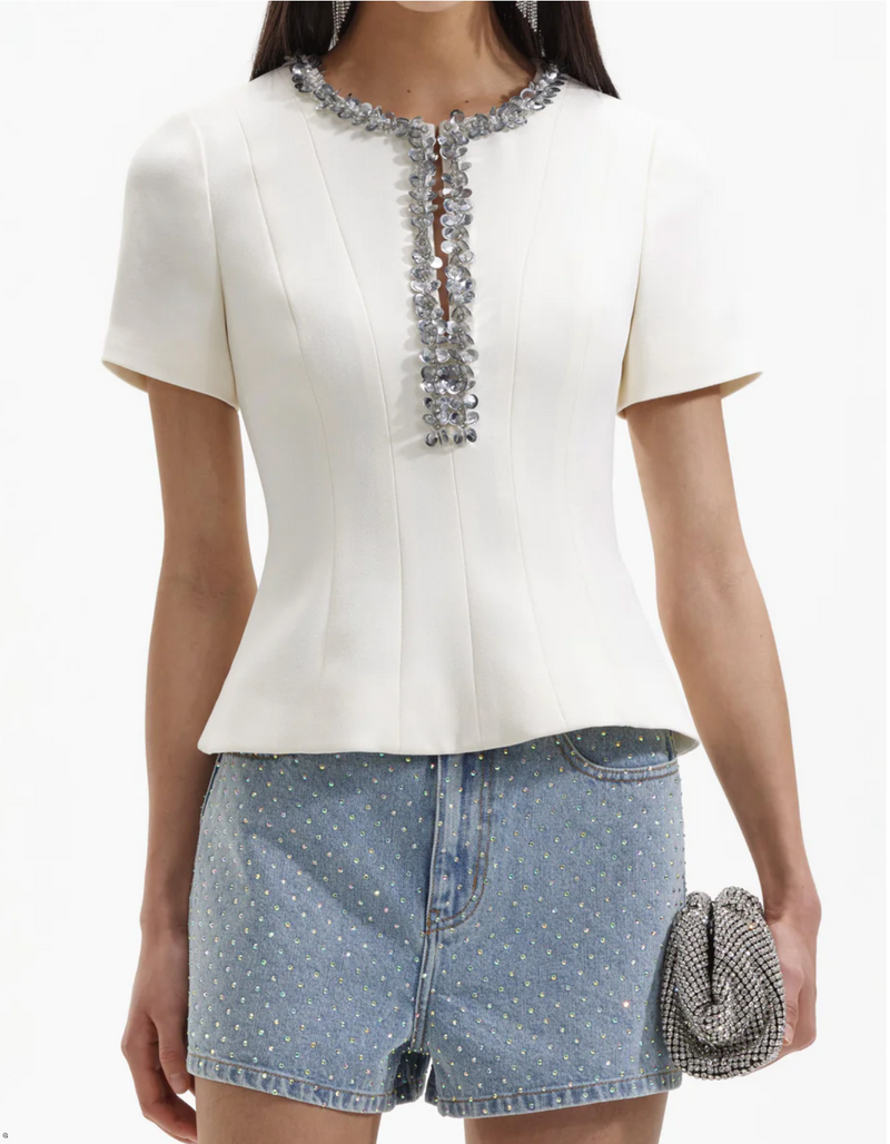 Ecru structured top with split crew neckline short sleeves and silver sequin and beaded detail about the neckline