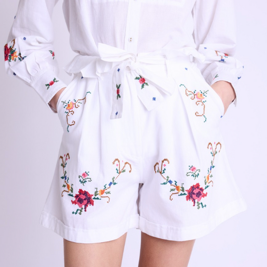 White paperbag shorts with colourful floral cross stitch details pleated front and pockets