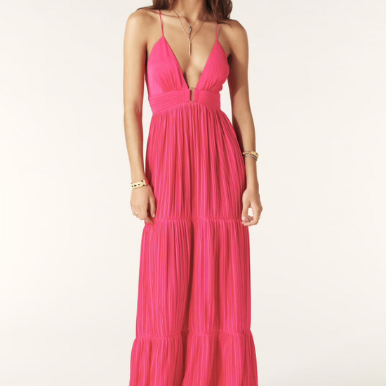 Fuchsia pink maxi dress with a deep v neckline and spaghetti straps that lace up the back