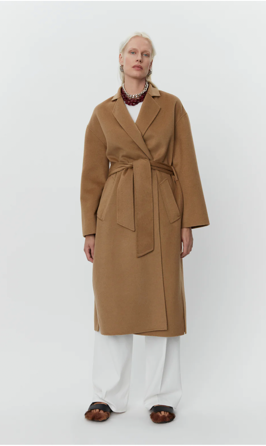 camel coat with belt and side slits front view